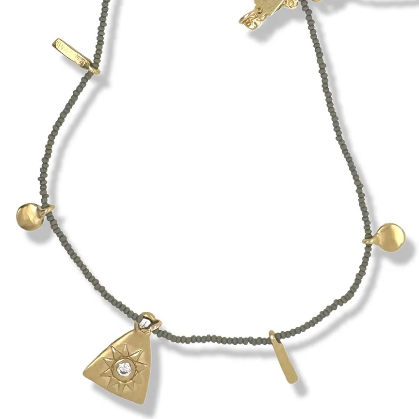 AILZ MULTI CHARM NECKLACE IN GOLD ON CHARCOAL BEADS